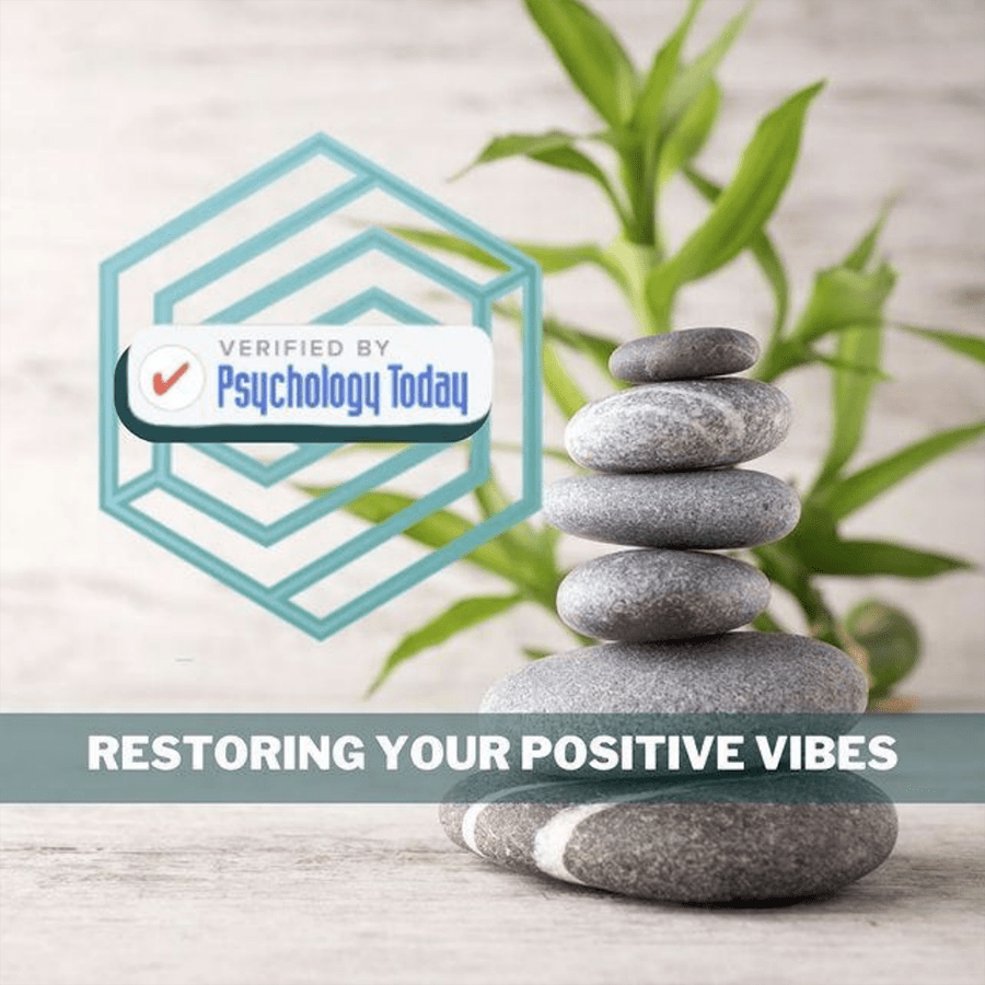 Image of a serene stack of smooth stones with a green plant in the background. An icon of a blue hexagon with the text "Verified by Psychology Today" is on the left. The text "Restoring Your Positive Vibes" is written across the bottom.