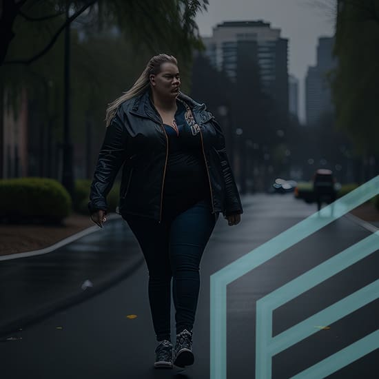 A woman with long hair walks confidently along a dimly lit, empty city street on a gloomy day. She is dressed casually in a dark jacket and jeans. The background shows blurred buildings and trees, with neon geometric shapes overlaying the lower right corner of the image.