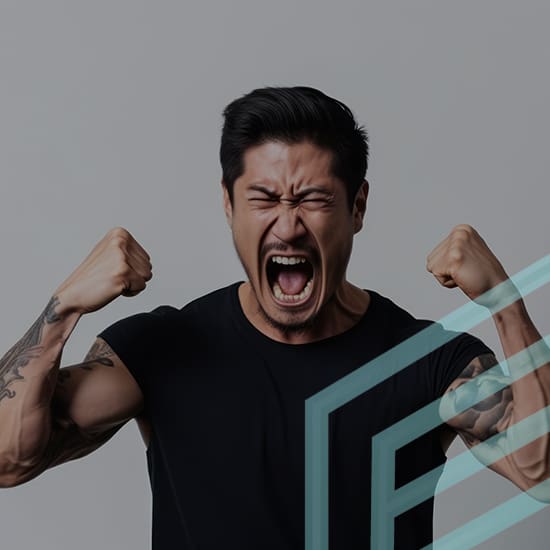 A man with dark hair and tattoos on his arms is wearing a black shirt and clenching his fists while shouting. The background is a plain gray, and there are abstract light blue geometric shapes partially overlaying the image on the right side.