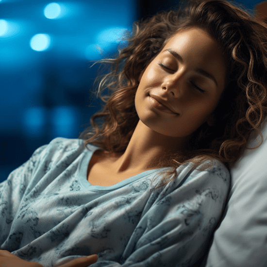 A woman with curly hair peacefully sleeps on her back, wearing a light blue patterned top. The background is softly blurred, featuring blue tones that suggest nighttime. The lighting is gentle, highlighting her relaxed and serene expression.