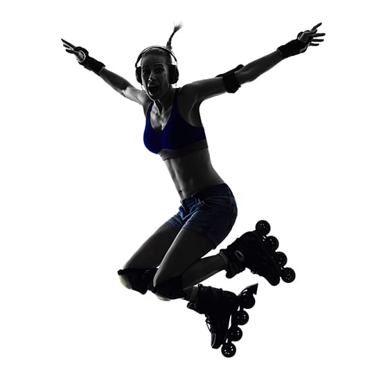 Silhouette of a person jumping mid-air while rollerblading. They are wearing a sports bra, shorts, knee pads, elbow pads, wrist guards, and headphones. Arms are spread wide, and one knee is bent.